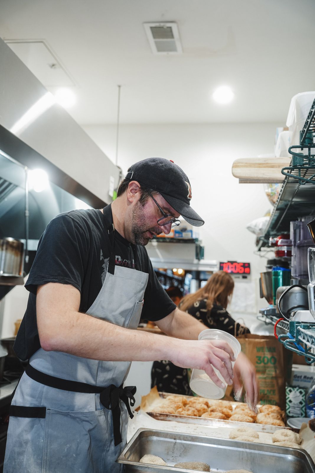 A baker shaping bagel dough in the kitchen