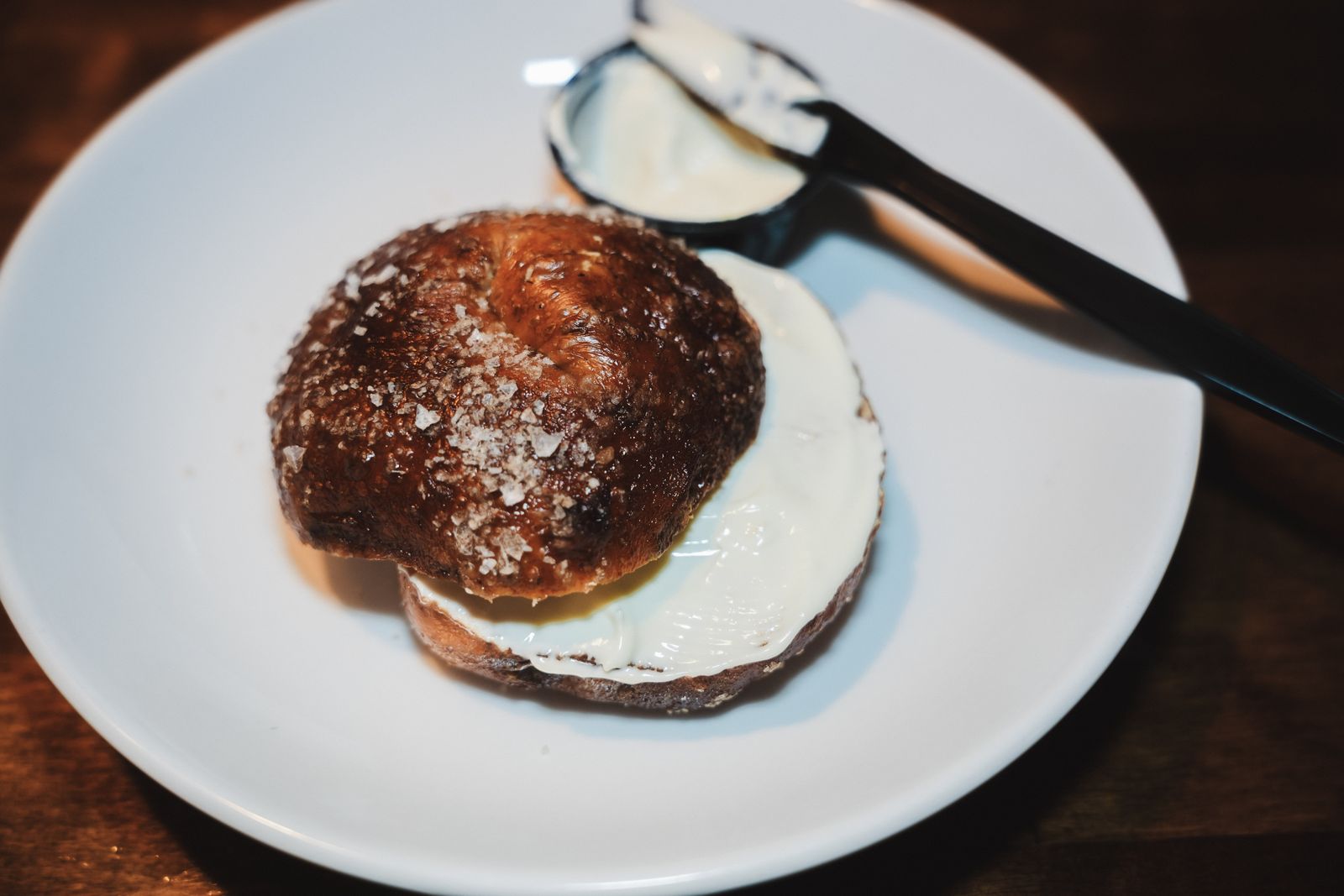 A pretzel bagel with a generous schmear of cream cheese